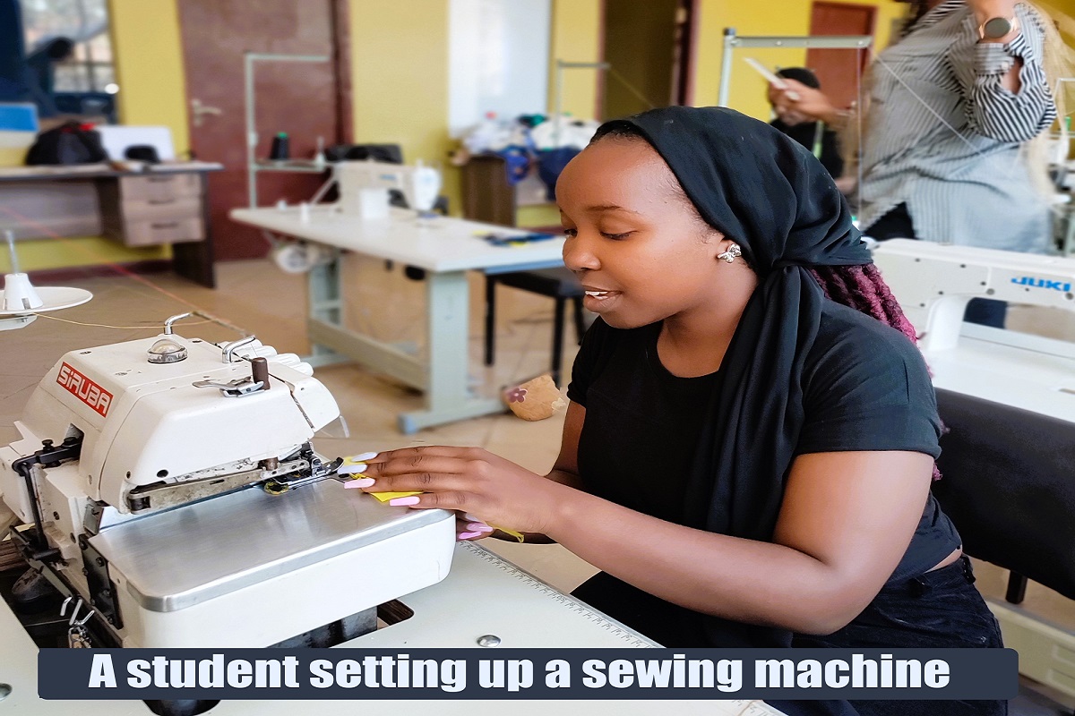 Ivy- A fashion student designer working on a button hole machine at the Hub
